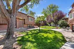 View of green lawn featuring a patio