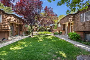 View of green lawn featuring a residential view