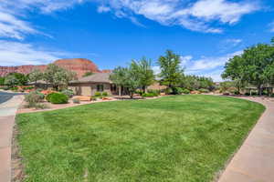 View of grassy yard with a mountain view