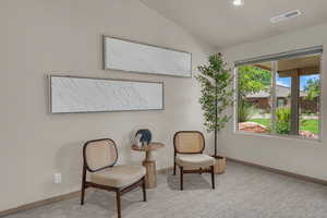 Living area featuring baseboards, lofted ceiling, carpet floors, and recessed lighting