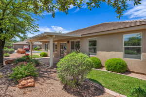 View of front of house with stucco siding, a tiled roof, a pergola, and a patio