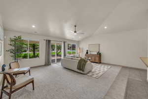 Living room with a ceiling fan, recessed lighting, vaulted ceiling, baseboards, and light tile patterned flooring