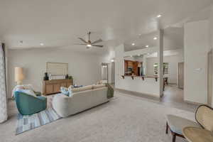 Living room with vaulted ceiling, a ceiling fan, recessed lighting, light tile patterned floors, and baseboards