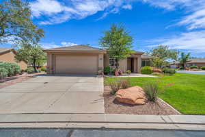 View of front of house with a garage, stucco siding, concrete driveway, a front lawn, and stone siding