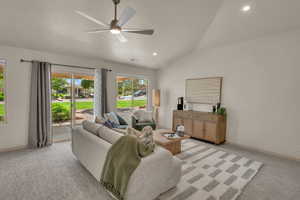 Living room featuring ceiling fan, lofted ceiling, light carpet, baseboards, and recessed lighting