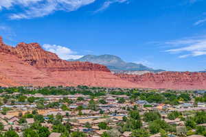 View of mountain backdrop featuring nearby suburban area