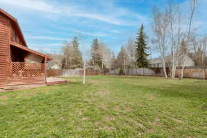 View of yard with a wooden deck