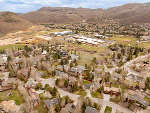 Aerial view of property's location with nearby suburban area and mountains