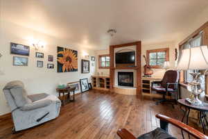 Living area featuring hardwood / wood-style floors and a large fireplace