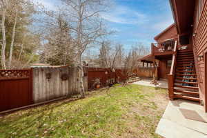 View of yard featuring stairs and a deck