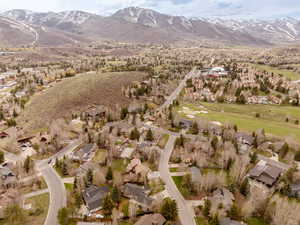 Aerial overview of property's location featuring mountains and nearby suburban area