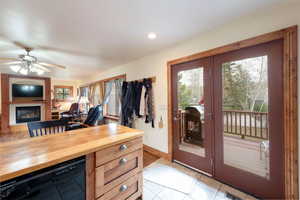 Office area featuring a glass covered fireplace, light tile patterned flooring, baseboards, a ceiling fan, and recessed lighting