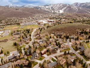 Aerial view of property's location featuring mountains and nearby suburban area