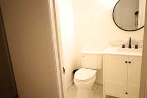 Bathroom featuring vanity, tasteful backsplash, toilet, and tile patterned flooring