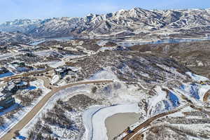 Snowy aerial view with a water and mountain view