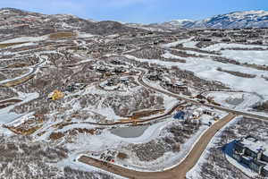Snowy aerial view featuring a mountain view