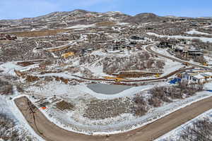 Snowy aerial view featuring a mountain view