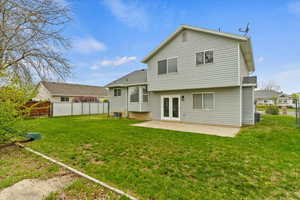Back of property with a patio and central air condition unit