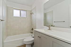 Full bathroom with toilet, vanity, and washtub / shower combination