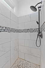 Full bath featuring tiled shower