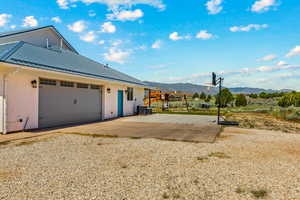 View of home's exterior featuring a mountain view, stucco siding, a standing seam roof, metal roof, and central AC unit