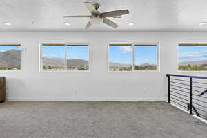 Carpeted spare room with a textured ceiling, recessed lighting, healthy amount of natural light, baseboards, and ceiling fan