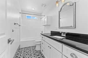 Full bathroom with vanity, shower / tub combination, and tile patterned flooring