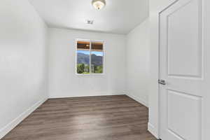Unfurnished room featuring baseboards and wood finished floors