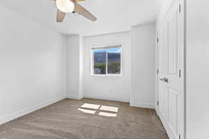 Unfurnished bedroom featuring carpet flooring and a ceiling fan