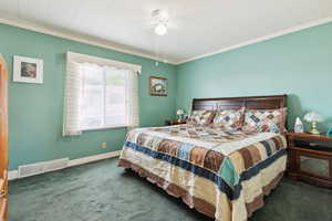 Bedroom with carpet, ornamental molding, and baseboards