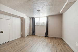 Unfurnished bedroom featuring wood-type flooring and baseboards