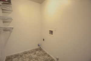 Laundry area with hookup for a washing machine, baseboards, electric dryer hookup, and gas dryer hookup