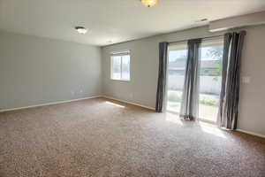 Carpeted empty room with baseboards