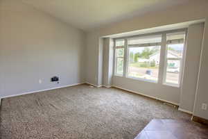 Carpeted empty room featuring baseboards