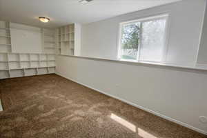 Unfurnished room with carpet floors and baseboards