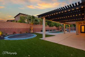 View of yard with a trampoline and a patio area
