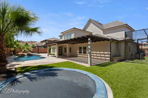 Rear view of house with stucco siding, a patio, and a tiled roof