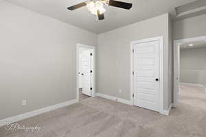 Unfurnished bedroom featuring carpet flooring, baseboards, and connected bathroom