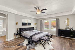 Virtually Staged primary bedroom featuring arched walkways,