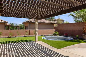 View of patio with a trampoline, a pergola, and a mountain view