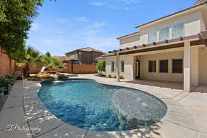 View of pool with a fenced backyard and a patio