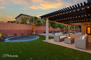 View of patio / terrace featuring a trampoline and an outdoor living space with a fire pit