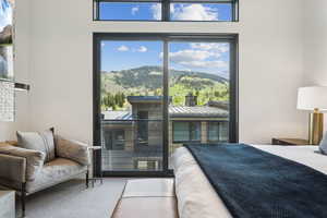 Primary bedroom with a mountain view and access to outside