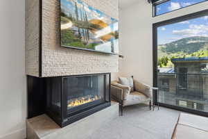 Primary Bedroom Detailed view of a glass covered fireplace and baseboards