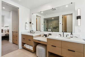 Primary Full bath featuring vanity, a stall shower, connected bathroom, tile patterned floors, and recessed lighting