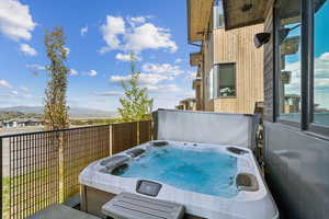 View of patio / terrace with a hot tub and a mountain view