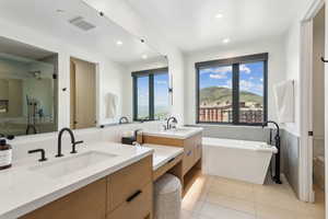 Primary Bathroom with vanity, tile patterned floors, a freestanding tub, recessed lighting, and a stall shower