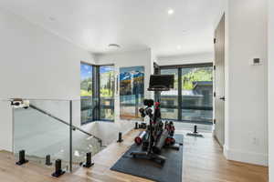 Workout area with plenty of natural light, hardwood / wood-style flooring, recessed lighting, and baseboards