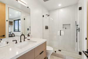 Full bath featuring toilet, a stall shower, vanity, recessed lighting, and tile patterned flooring