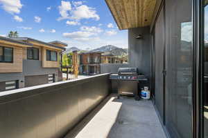 Balcony with a mountain view, grilling area, and a residential view